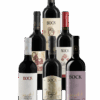 Group of seven Bock wine bottles arranged together, showcasing white and red labels with gold accents.