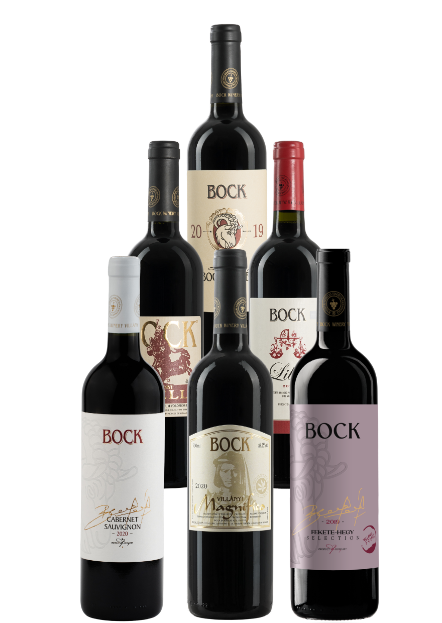 Group of seven Bock wine bottles arranged together, showcasing white and red labels with gold accents.
