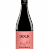 Bottle of Bock Kadarka wine with a pink label and gold signature, 2022 vintage, dark glass bottle on a black background