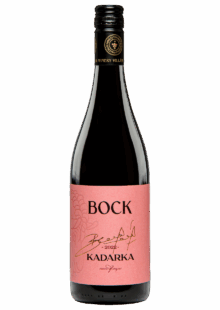 Bottle of Bock Kadarka wine with a pink label and gold signature, 2022 vintage, dark glass bottle on a black background