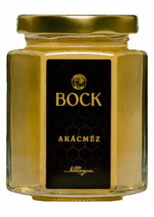Glass jar of acacia honey with a black label reading 'BOCK' in gold lettering and a gold lid.