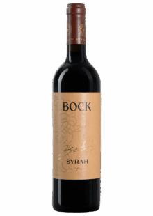 Bottle of Bock Syrah red wine with a tan label and gold script visible on the front